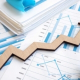 Business growth concept. Financial report with graphs and arrow.